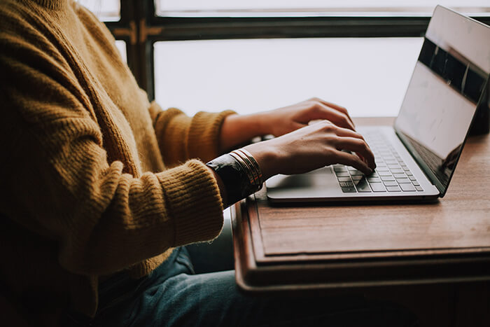 A person typing on a computer