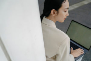 A lady sitting with a laptop in her lap